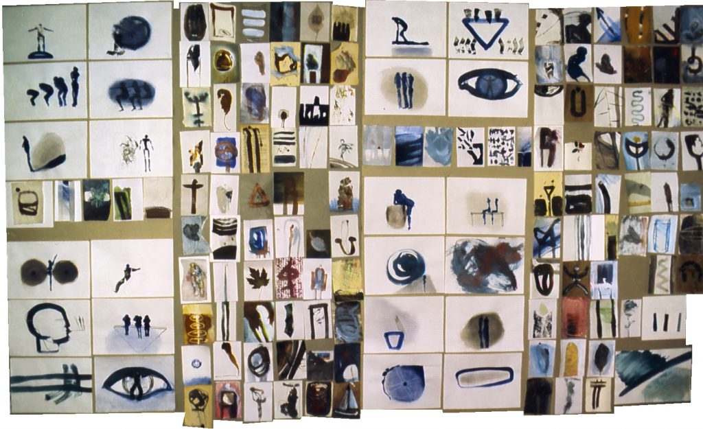 Large studio wall grid display of numerous small sketches and book pages in acrylic and gouache on paper, featuring abstract figures, symbols, and forms in blues, browns, golds, and earth tones, Kleinseebach, Germany, 1988